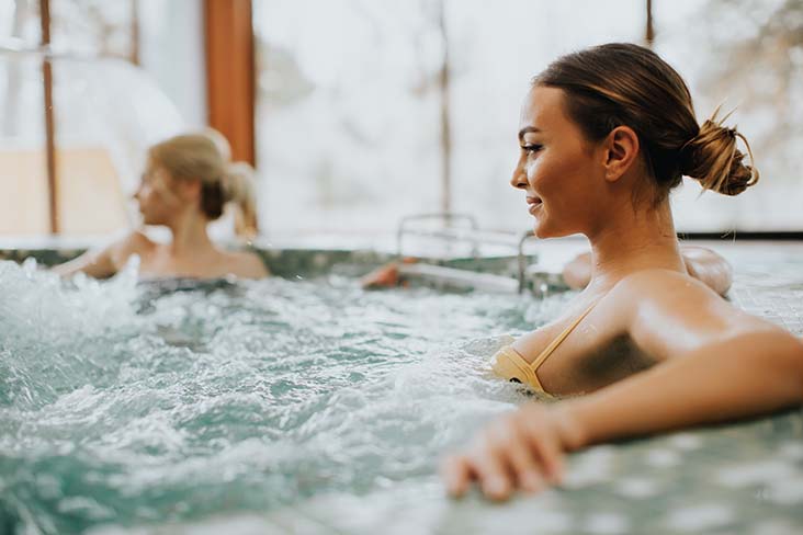 women sitting in hot tub
