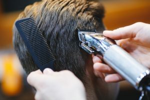 clippers cutting man's hair