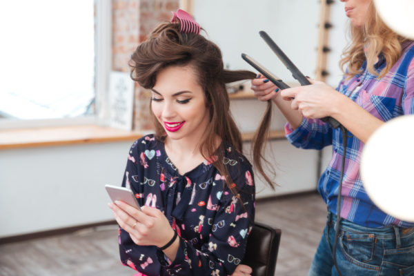 salon customer getting her hair straightened