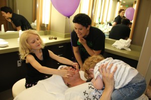 Daughter giving facial for mom