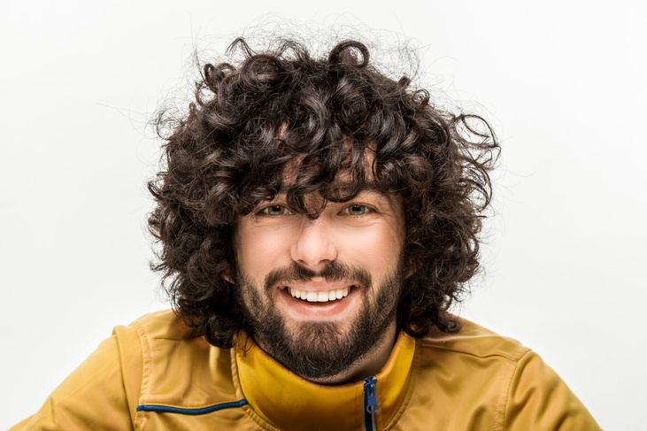 man posing with curly hair