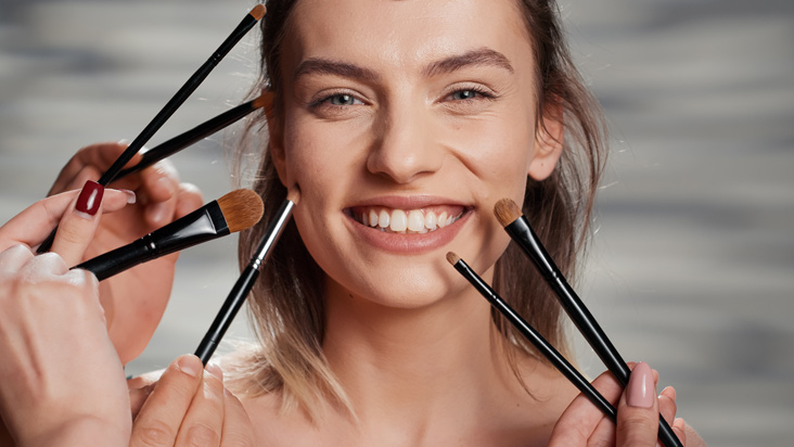 girl posing with brushes