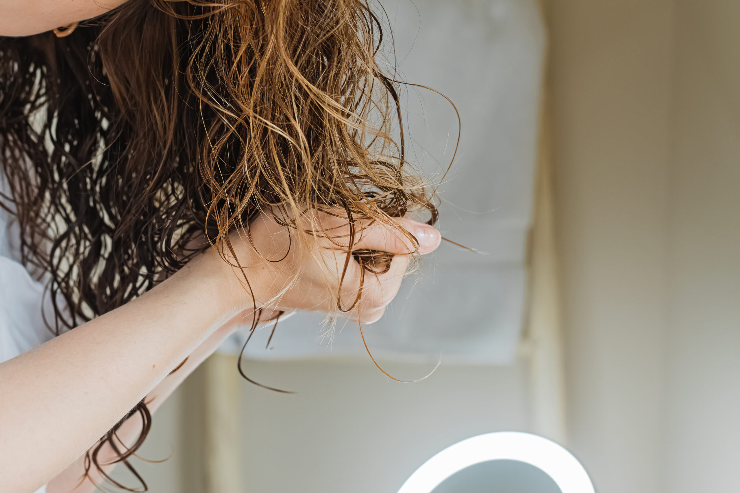 woman scrunching wet hair