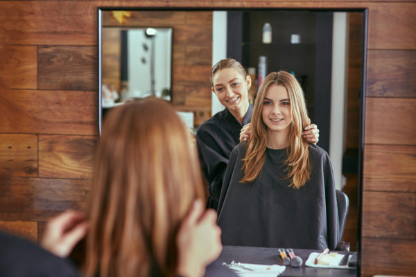 professional hairstylist consulting with a happy customer