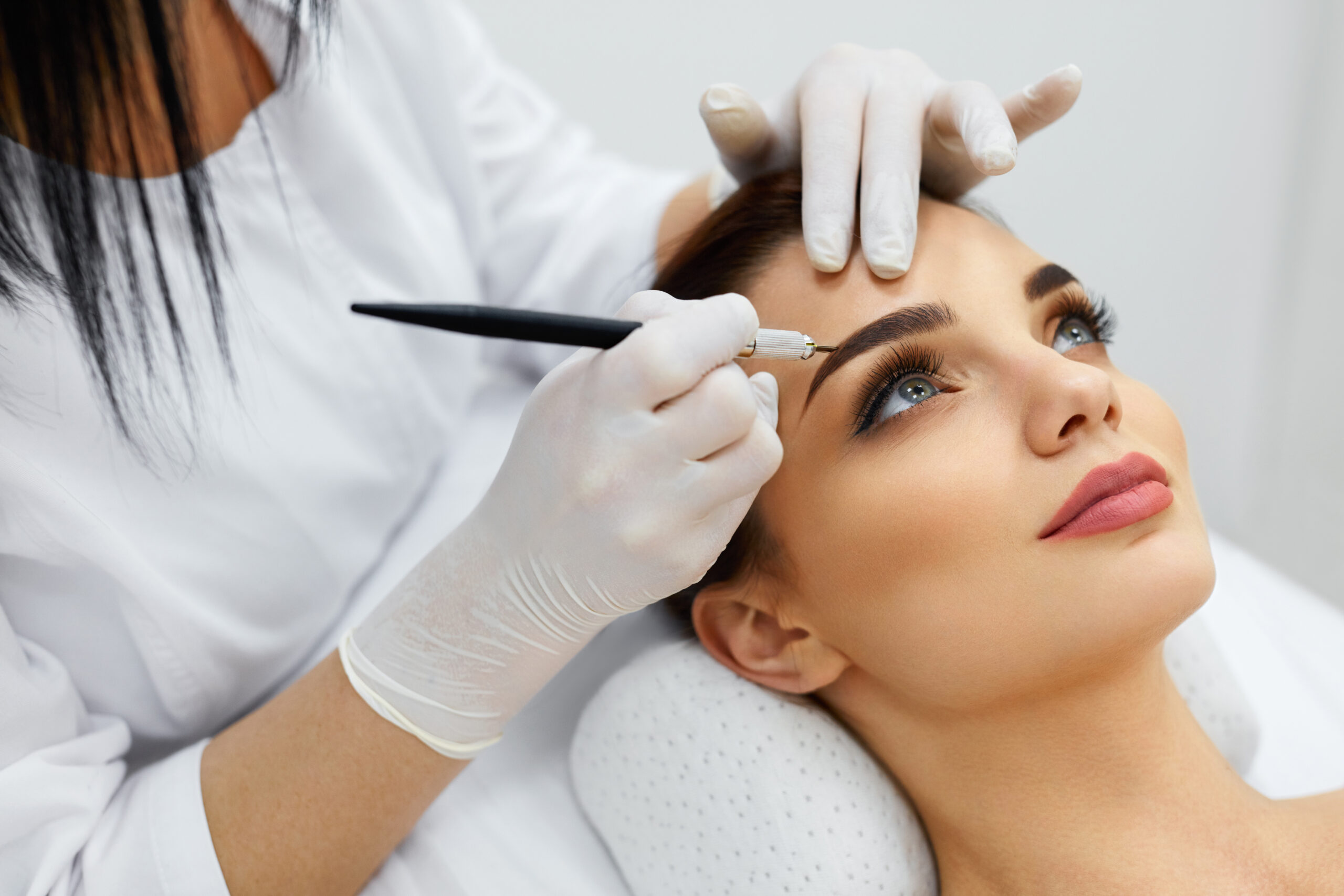 woman getting permanent cosmetic