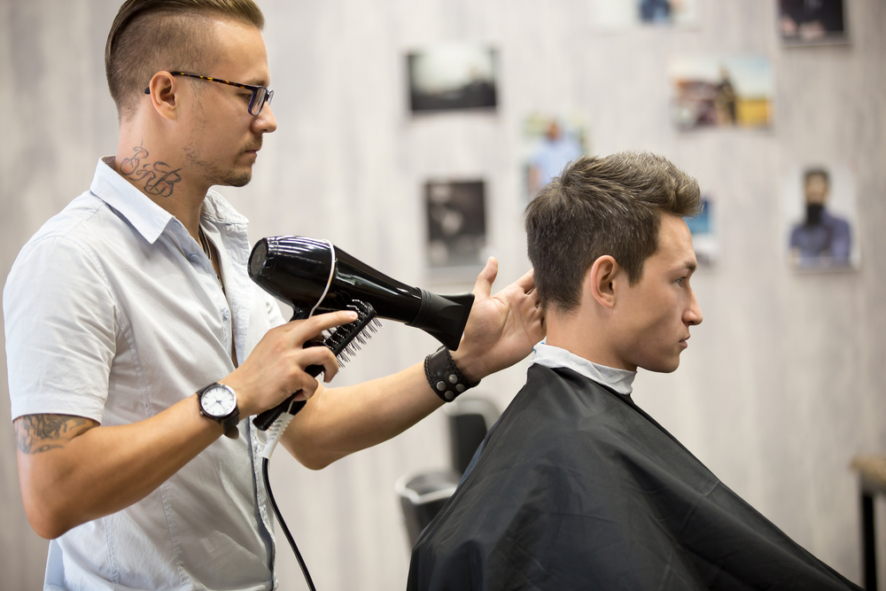 male stylist cutting a man's hair