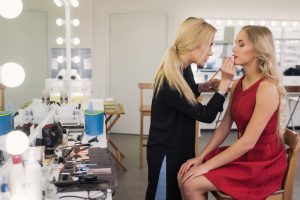 makeup artist working on a female model