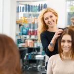 hairdresser doing client's hair