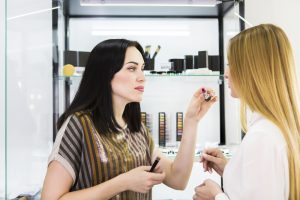 beauty consultant working on client