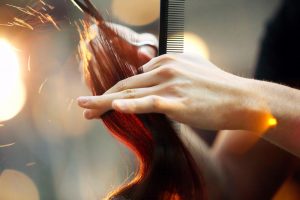 cosmetologist cutting hair