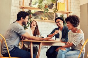 Friends laughing together at cafe