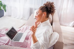 Woman listening to music through headphones