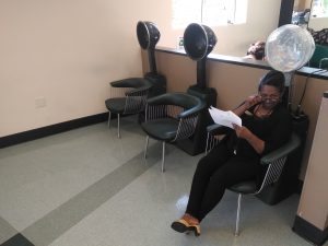 Evergreen employee "Zed" sitting in salon chair