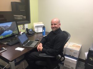 Evergreen employee "Mike" sitting at his desk