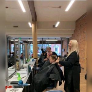 girls doing hair in a barber shop 