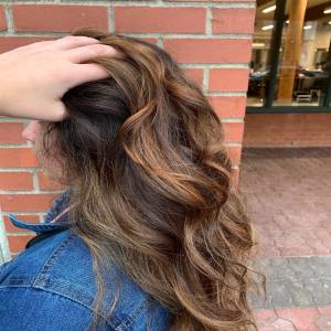 girl running fingers through brunette curly hair