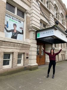 Women in front of building sign