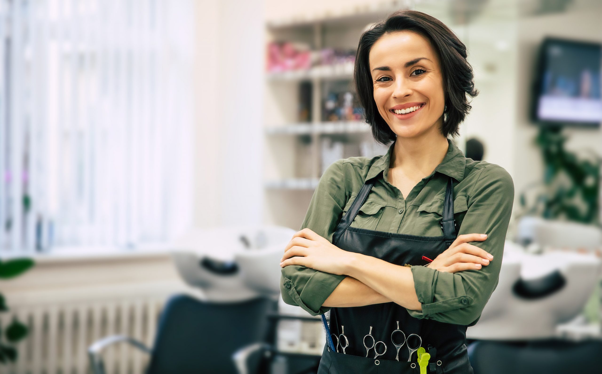 Smiling cosmetology professional in salon