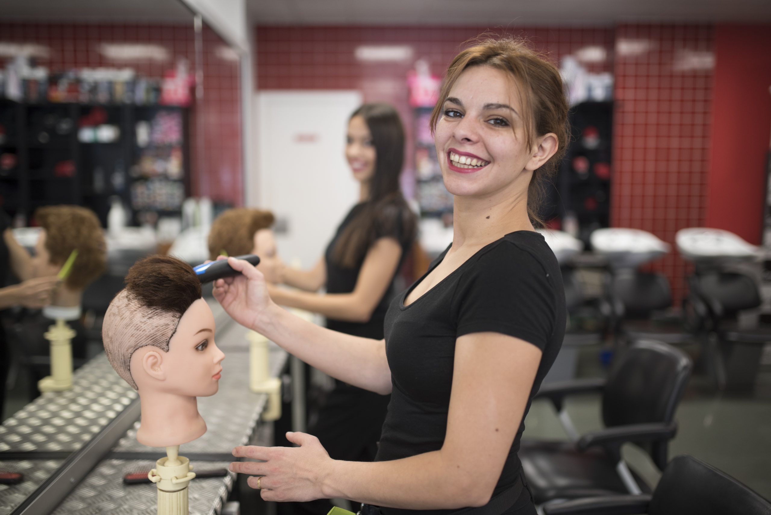 student learning how to cut hair