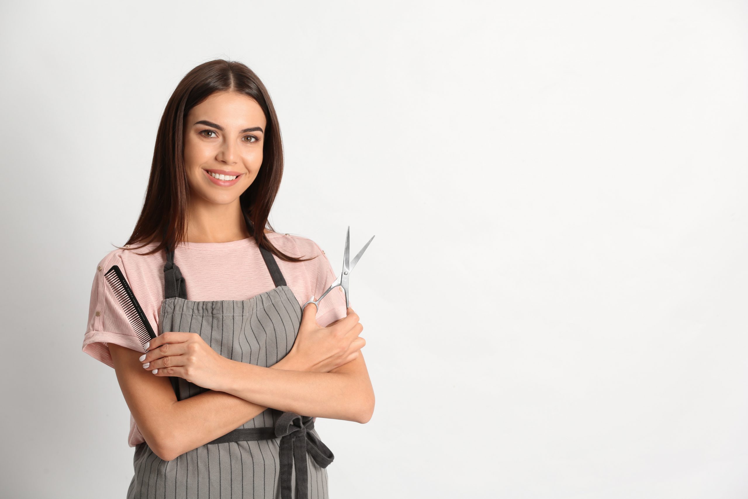 Hairstylist holding scissors and comb