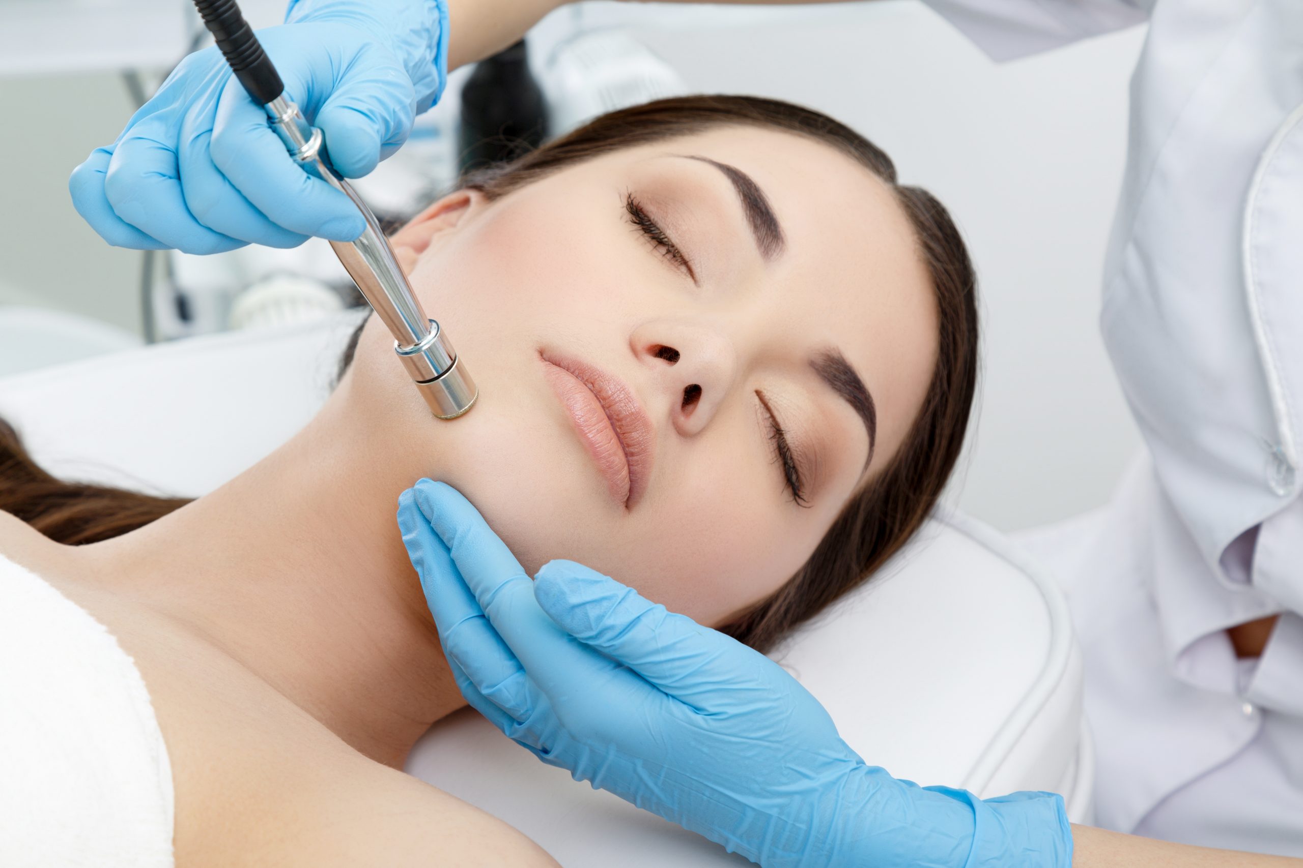 cosmetologist doing microdermabrasion procedure