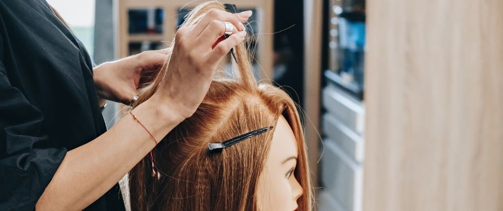 Training hairstyling on a mannequin