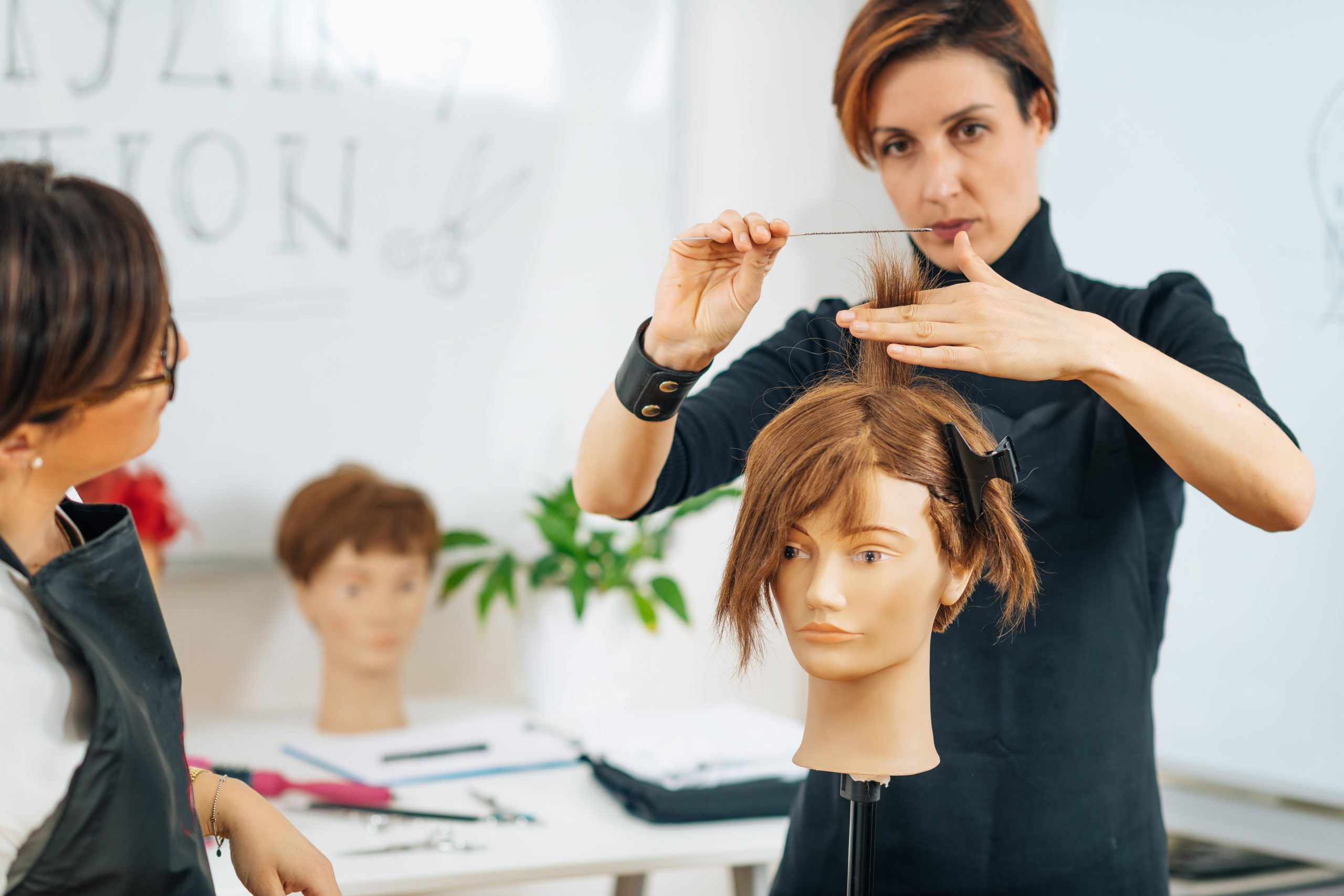 student and teacher at haircutting class