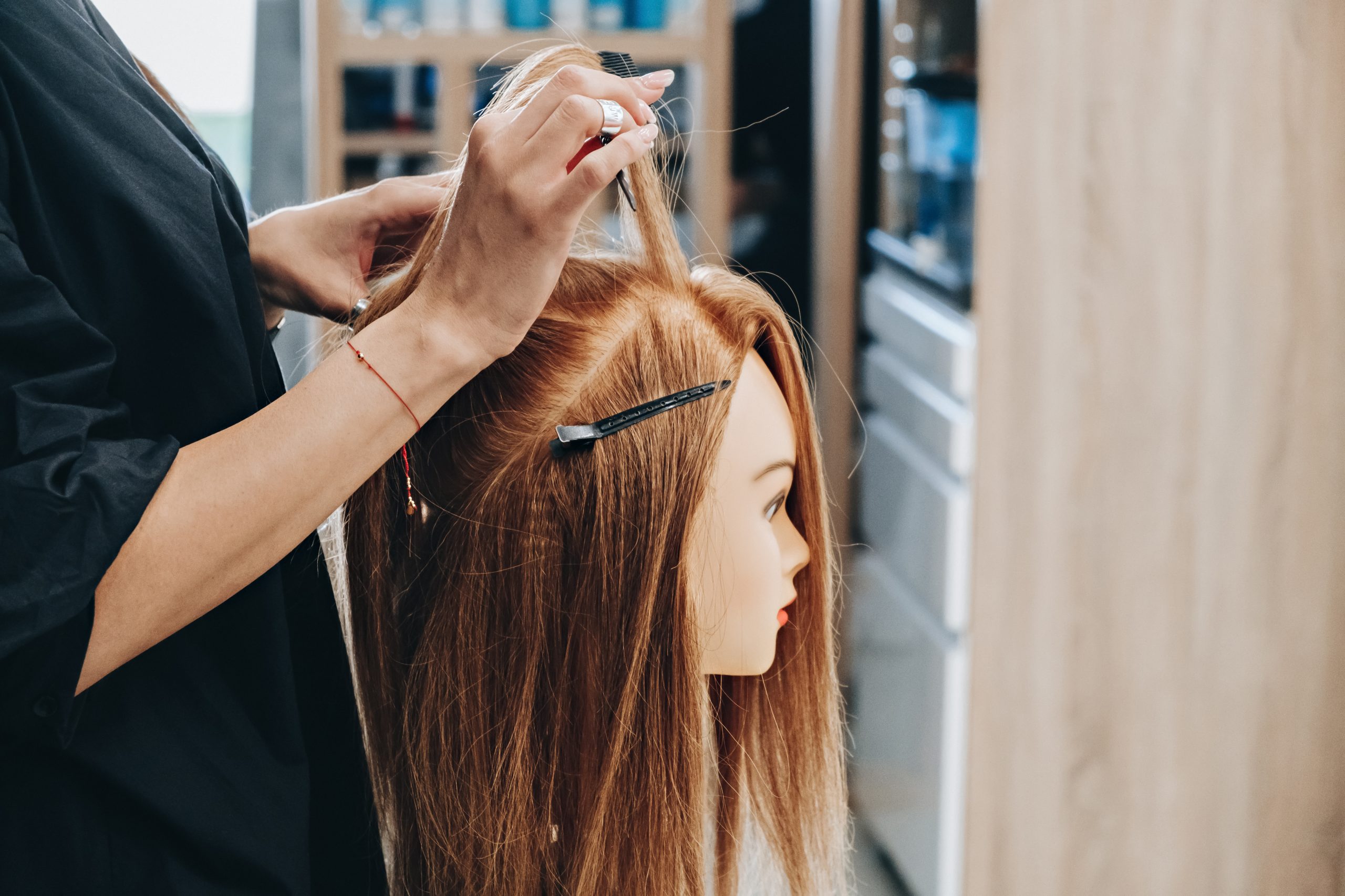 Training hairstyling on a mannequin