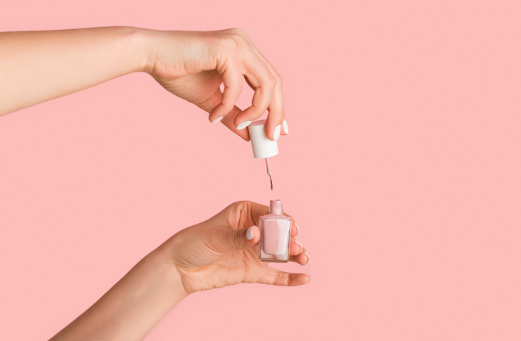 woman holding nail polish