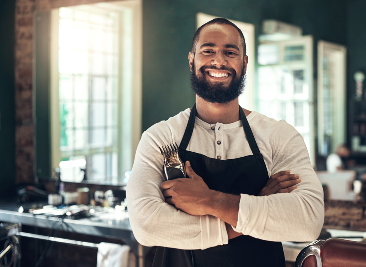 man with shears posing proudly