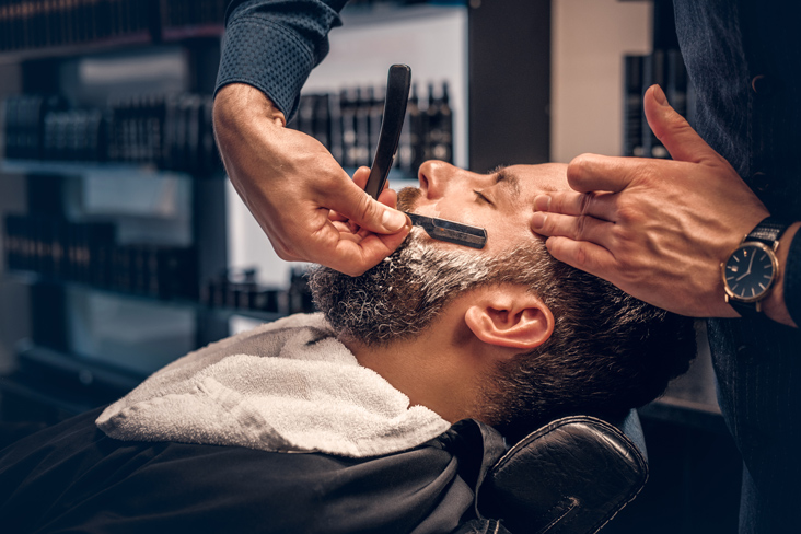 man getting shave from barber