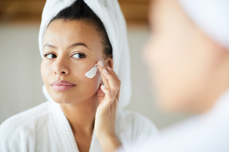 applying cream to face