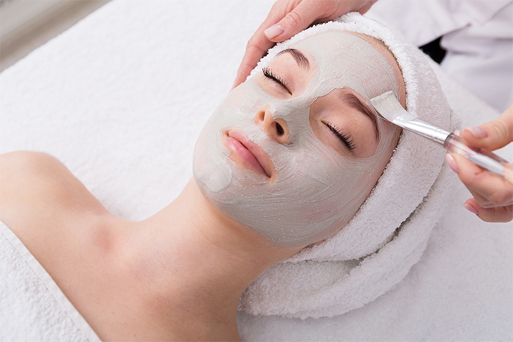 esthetician applying face mask