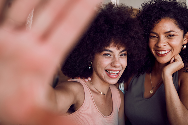 women posing in front of camera