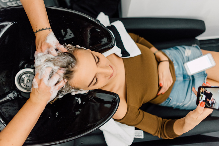 woman’s hair being washed