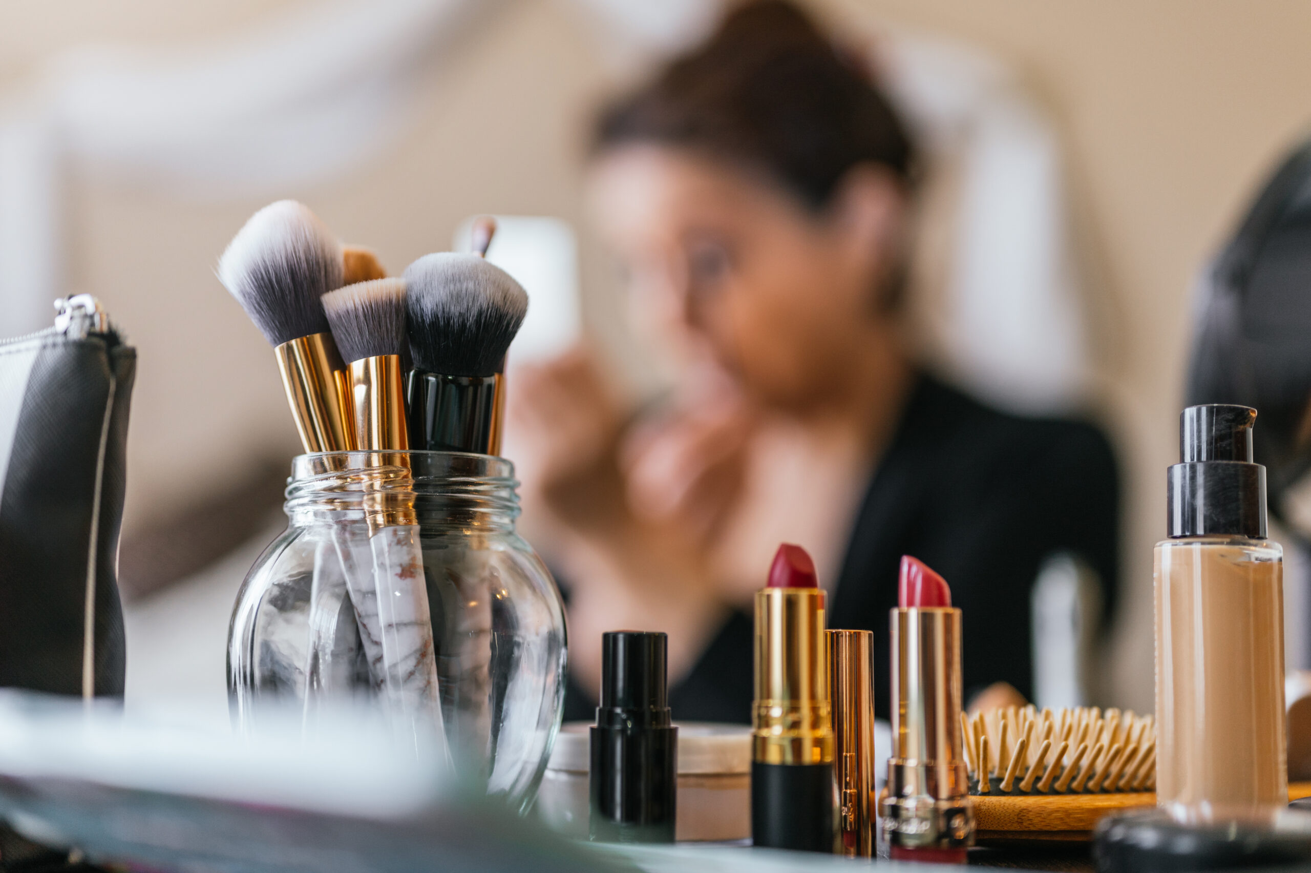 background of woman applying makeup