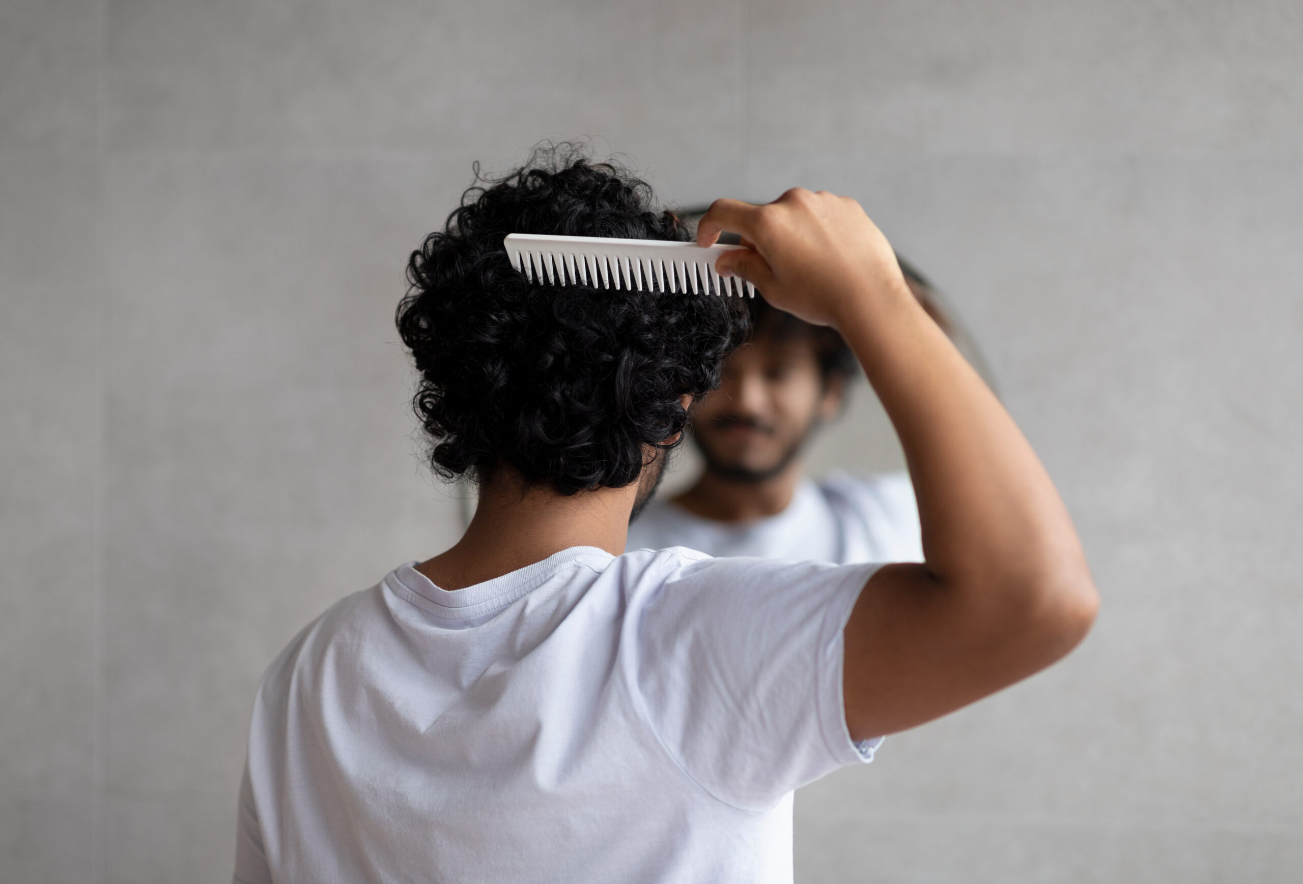 man combing his hair